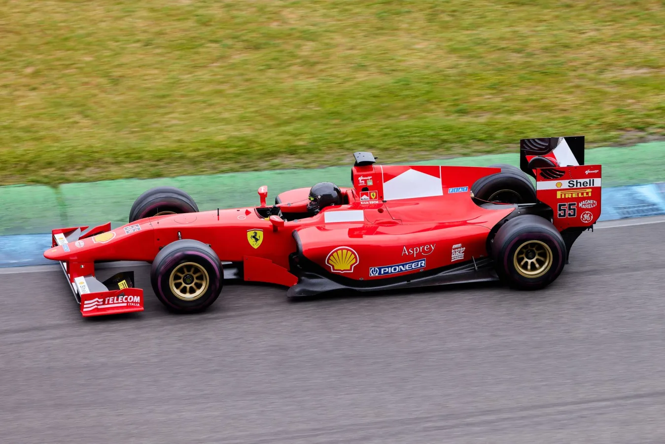 High-speed Formula 1 car in action on an outdoor racing track, showcasing motion and excit