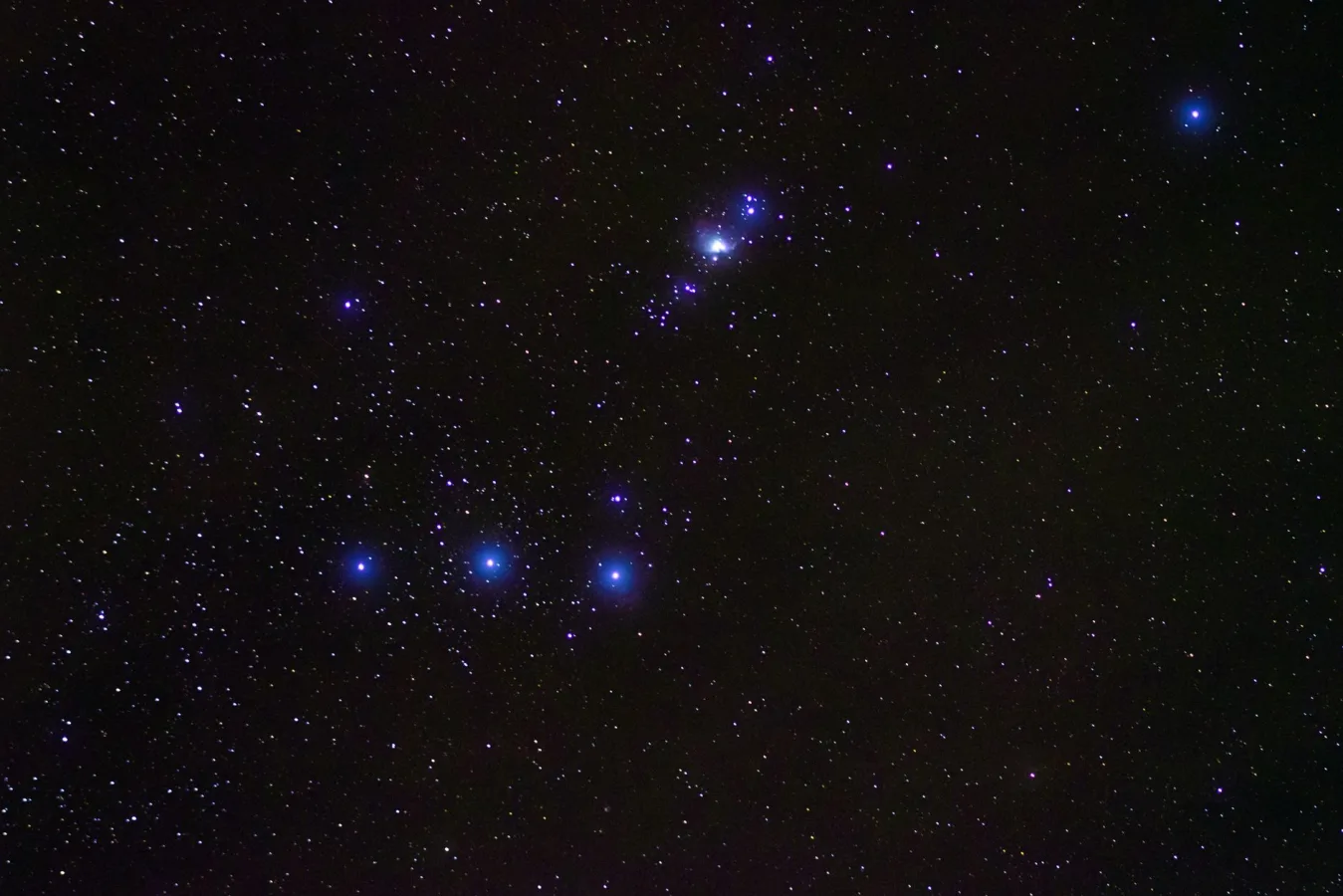 A breathtaking view of the Orion constellation surrounded by countless stars in the dark,