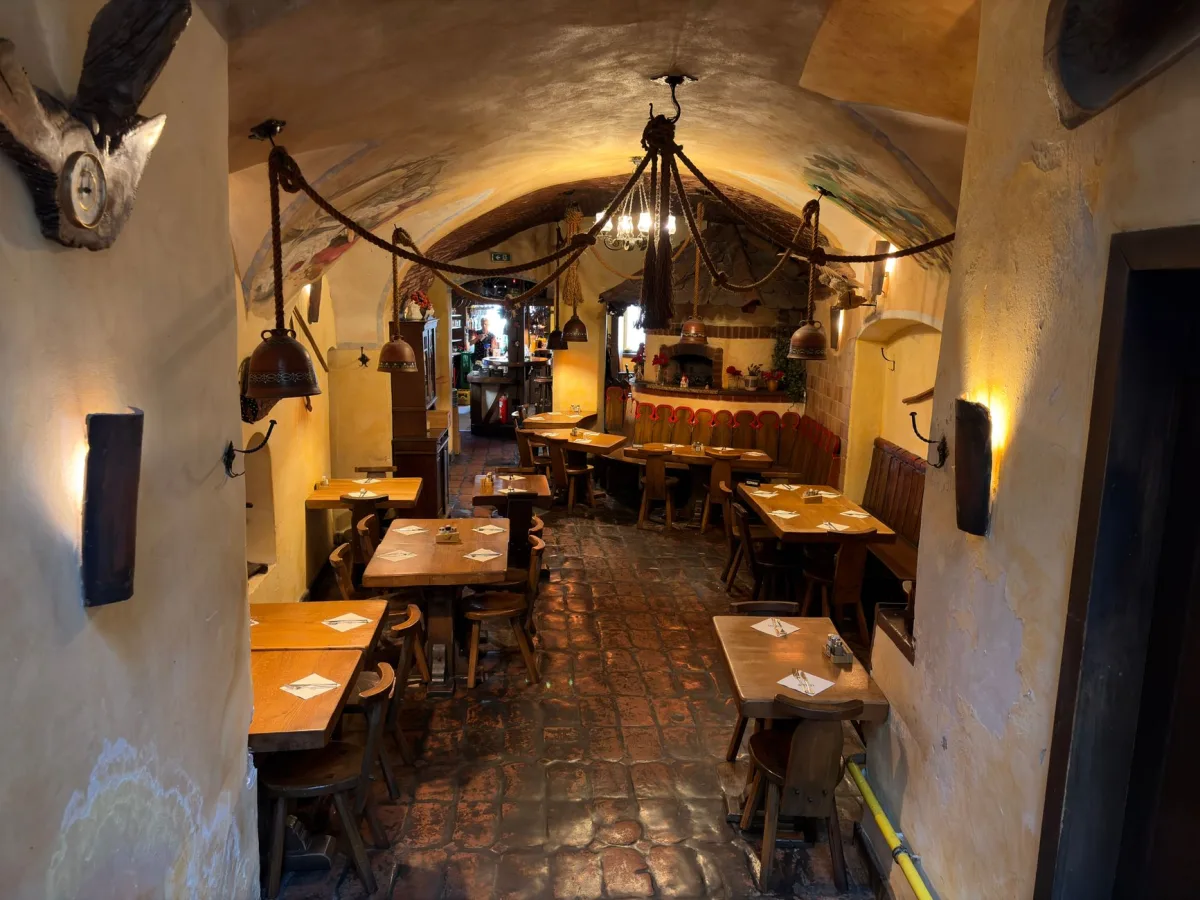Inviting restaurant interior in Slovenia featuring rustic decor and wooden furniture.