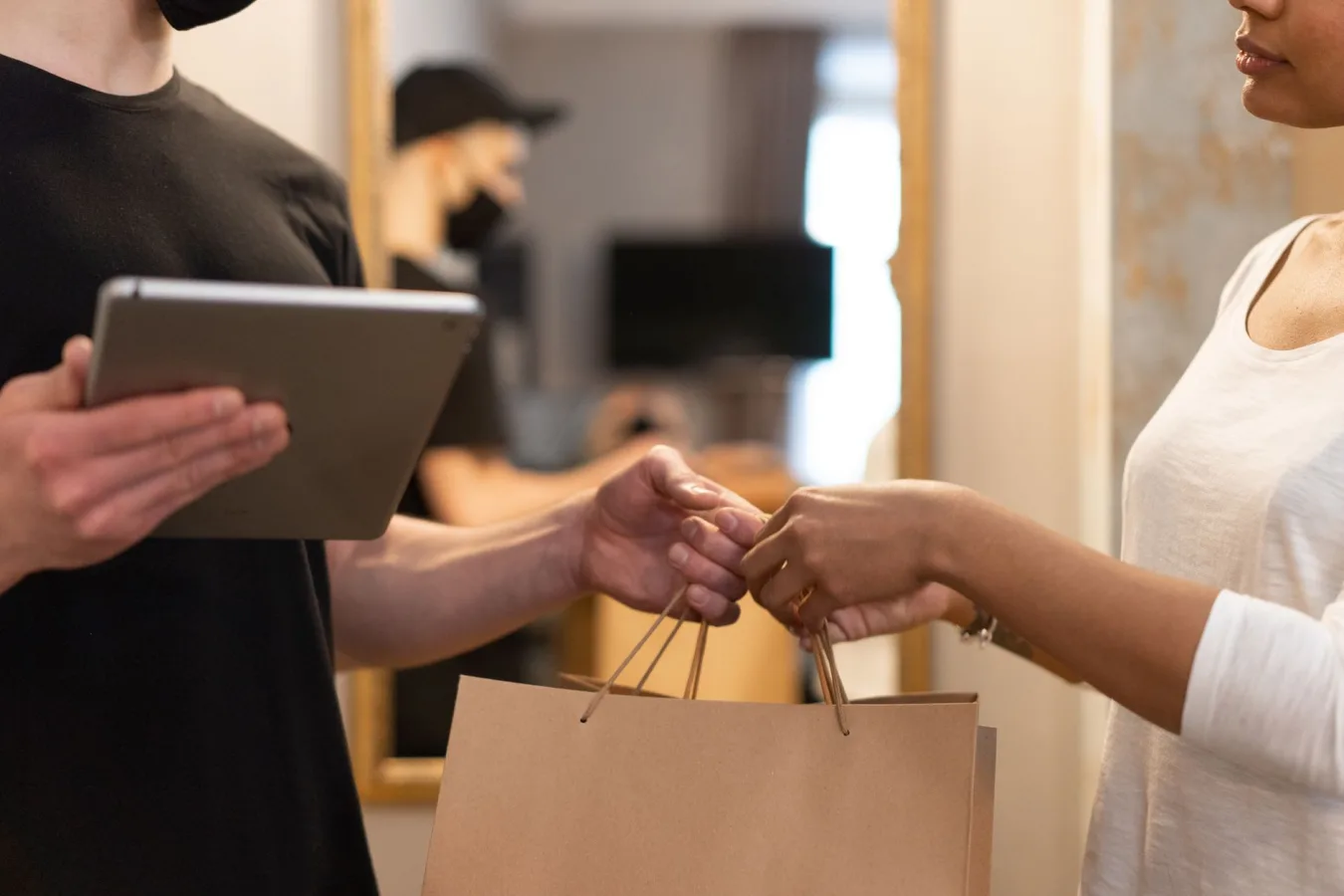Person holding a credit card while shopping online on a laptop, indicating ecommerce trans